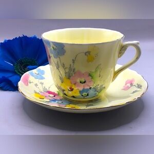 Crown Staffordshire Teacup & Saucer Pale Yellow w/Blue, Pink, and Yellow Flowers